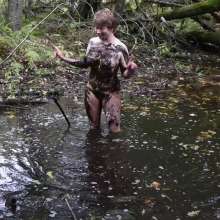 Stella: Stella splashes through forest swamp looking for a mud pit.