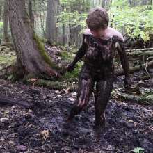 Stella: Stella splashes through forest swamp looking for a mud pit.