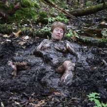 Stella: Stella splashes through forest swamp looking for a mud pit.