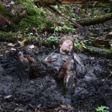 Stella: Stella splashes through forest swamp looking for a mud pit.