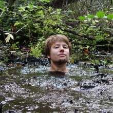 Stella: Stella splashes through forest swamp looking for a mud pit.