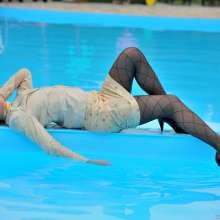 ufa217: Angela in a business suit swims in a pool.