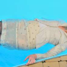 ufa217: Angela in a business suit swims in a pool.