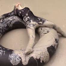 FOXY: video black unitard in mud