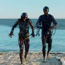 Gater: Ad find: A couple get completely covered in black oil in Adbusters' ad
