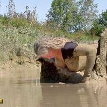 FOXY: In deep mud with red boots.