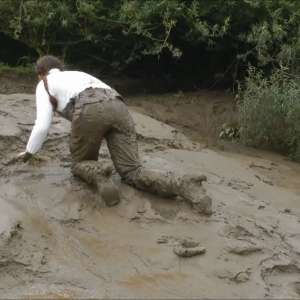 DungeonMasterOne: Mud: Chastity wears combats, heeled boots, white jumper, into the mudbanks!