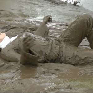 DungeonMasterOne: Mud: Chastity wears combats, heeled boots, white jumper, into the mudbanks!