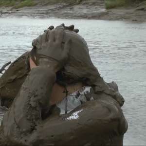 DungeonMasterOne: Mud: Chastity wears combats, heeled boots, white jumper, into the mudbanks!