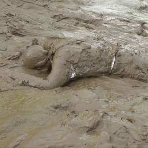 DungeonMasterOne: Mud: Chastity wears combats, heeled boots, white jumper, into the mudbanks!