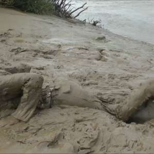 DungeonMasterOne: Mud: Chastity wears combats, heeled boots, white jumper, into the mudbanks!
