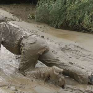 DungeonMasterOne: Mud: Chastity wears combats, heeled boots, white jumper, into the mudbanks!