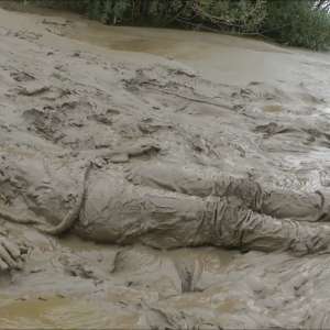 DungeonMasterOne: Mud: Chastity wears combats, heeled boots, white jumper, into the mudbanks!