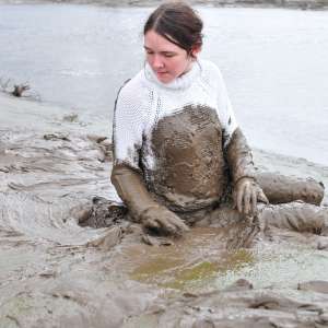 DungeonMasterOne: Mud: Chastity wears combats, heeled boots, white jumper, into the mudbanks!