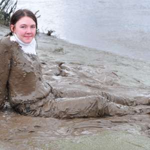 DungeonMasterOne: Mud: Chastity wears combats, heeled boots, white jumper, into the mudbanks!