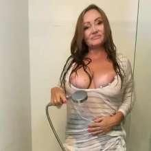 Wet_look_elena: Leather Jacket and Skirt with Stockings in the Shower.