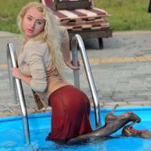 ufa217: Angelina in a dress and stockings swims in the pool.