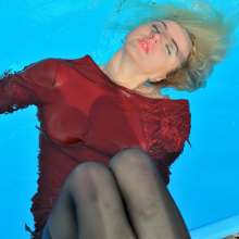 ufa217: Angelina in a dress and stockings swims in the pool.