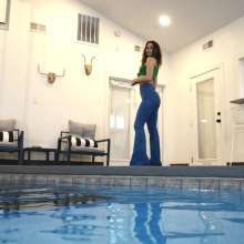 WetlookFashion: Lilith Swims in Flared Blue Jeans, Crop Top and High Heels