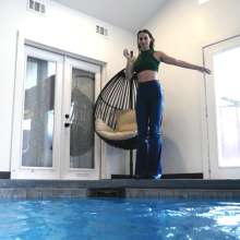 WetlookFashion: Lilith Swims in Flared Blue Jeans, Crop Top and High Heels