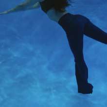 WetlookFashion: Lilith Swims in Flared Blue Jeans, Crop Top and High Heels