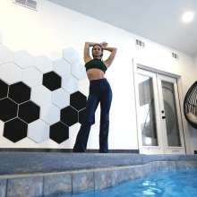 WetlookFashion: Lilith Swims in Flared Blue Jeans, Crop Top and High Heels