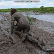 DungeonMasterOne: Miss Abigail belly-flops into the mud in a tight shiny jumpsuit!