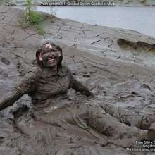 DungeonMasterOne: Miss Abigail belly-flops into the mud in a tight shiny jumpsuit!