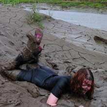 DungeonMasterOne: Miss Abigail belly-flops into the mud in a tight shiny jumpsuit!