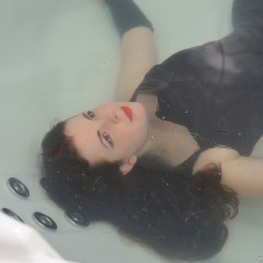 ufa217: Greta takes a bath in a gothic black dress.