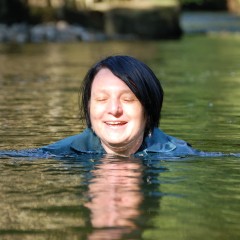 DungeonMasterOne: d/l: Evelyne soaking her coveralls in the river below the viaduct
