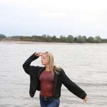 eileenvogel: Eileen in the river in jeans and fluffy jacket