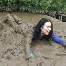 DungeonMasterOne: Mud!  Honeysuckle takes a river mudbath in a tight-fitting blue jumpsuit