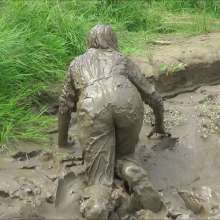 DungeonMasterOne: Mud!  Honeysuckle takes a river mudbath in a tight-fitting blue jumpsuit