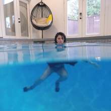 WetlookFashion: Bella Swimming in a Dress, Fishnet Tights and Heels