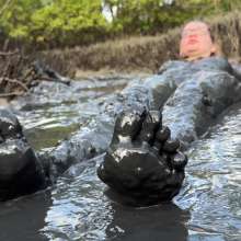 Messy Temptress: Hooters Girl Gets Playful in Pluff Mud