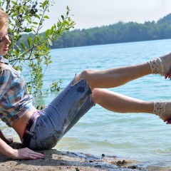 ufa217: Nika swims in the lake fully clothed.