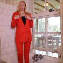 eileenvogel: W326 Eileen in red business suit showering after a hard day at work