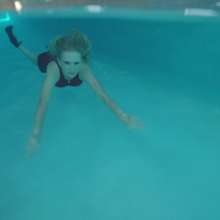 WetlookFashion: Angel Enjoys a Swim Wearing a Sexy Mini Skirt Outfit