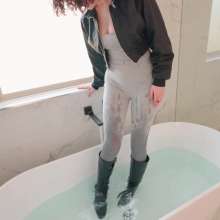 WetlookFashion: Elena Takes a Bath in a Jumpsuit, Boots and Leather Jacket