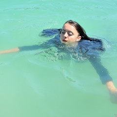 ufa217: Margaret swims in the lake fully clothed.