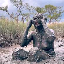 Messy Temptress: Muddy Fun in Converse and Fishnets