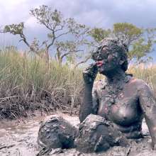 Messy Temptress: Muddy Fun in Converse and Fishnets