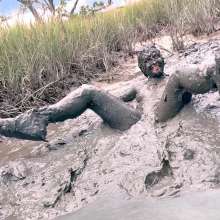 Messy Temptress: Muddy Fun in Converse and Fishnets
