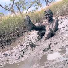 Messy Temptress: Muddy Fun in Converse and Fishnets