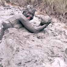 Messy Temptress: Muddy Fun in Converse and Fishnets