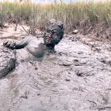 Messy Temptress: Muddy Fun in Converse and Fishnets