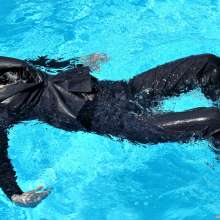 ufa217: Kira in a business suit swims in the pool.
