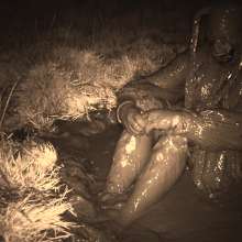 Swamp Angel: 86 Ir Latex Mask and Leather Skirt Mud Bath