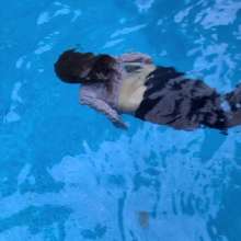 Wet Orchid: Wet Orchid Swims in Pool with Long Leather Jacket On.Clothed